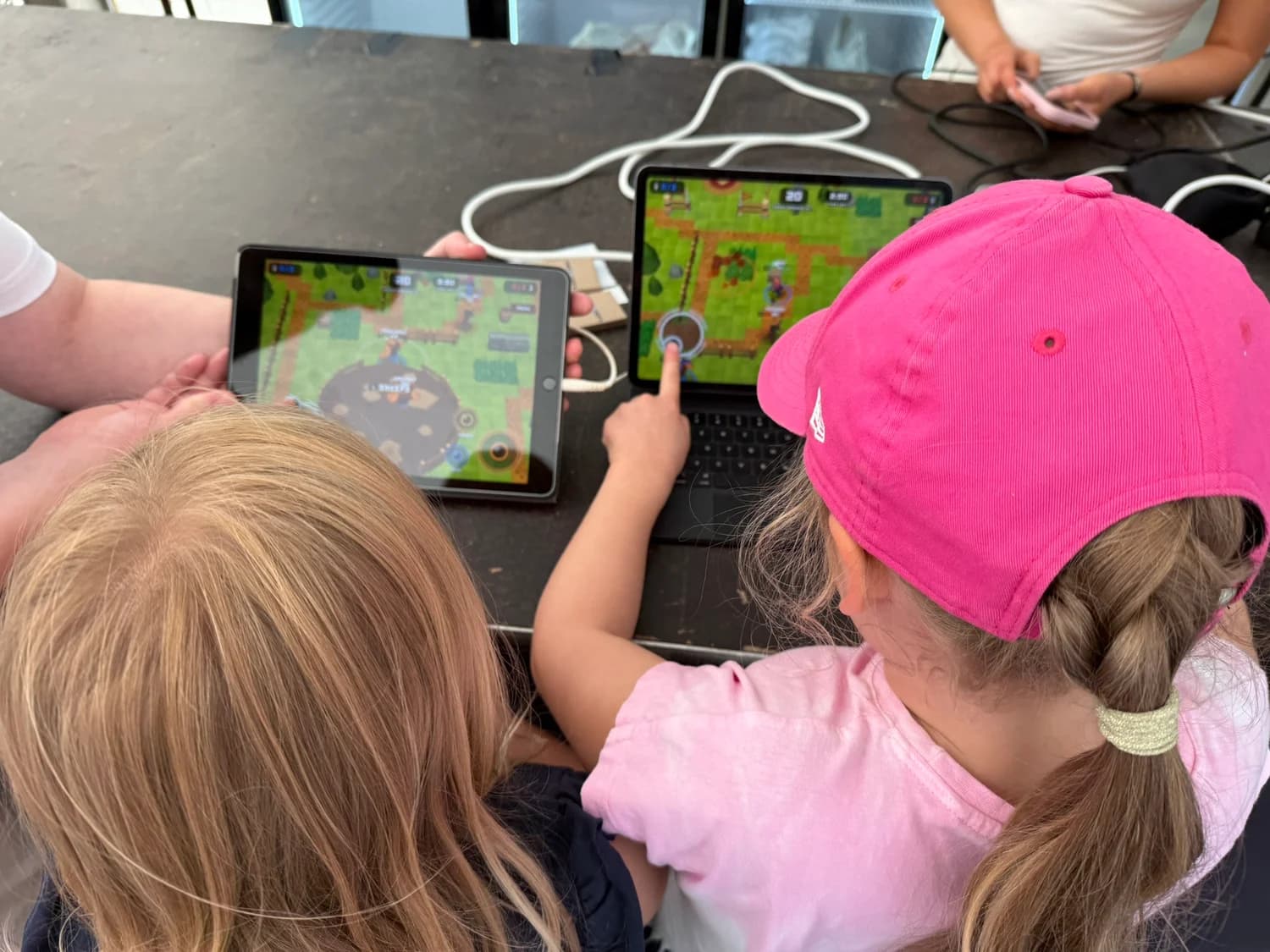 Two players trying Raivo Bull on tablets